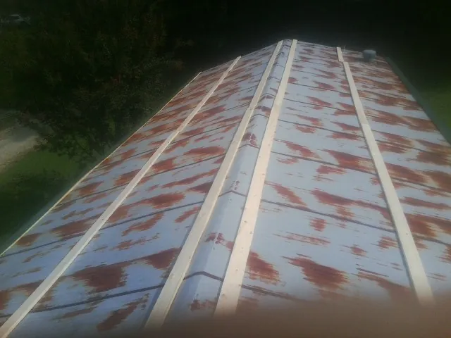 Rusted metal roof panels with new wood purlins before replacement — Storm Damage Roof Repair in Anza by Roofing Brothers