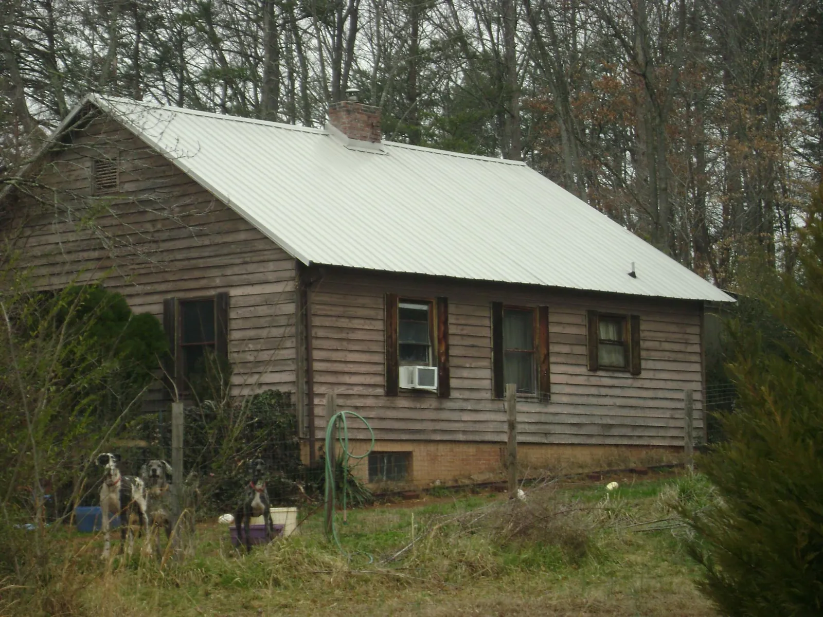 White metal roof on an old wood sided farmhouse, from a Metal Roof Installation job in Anza
